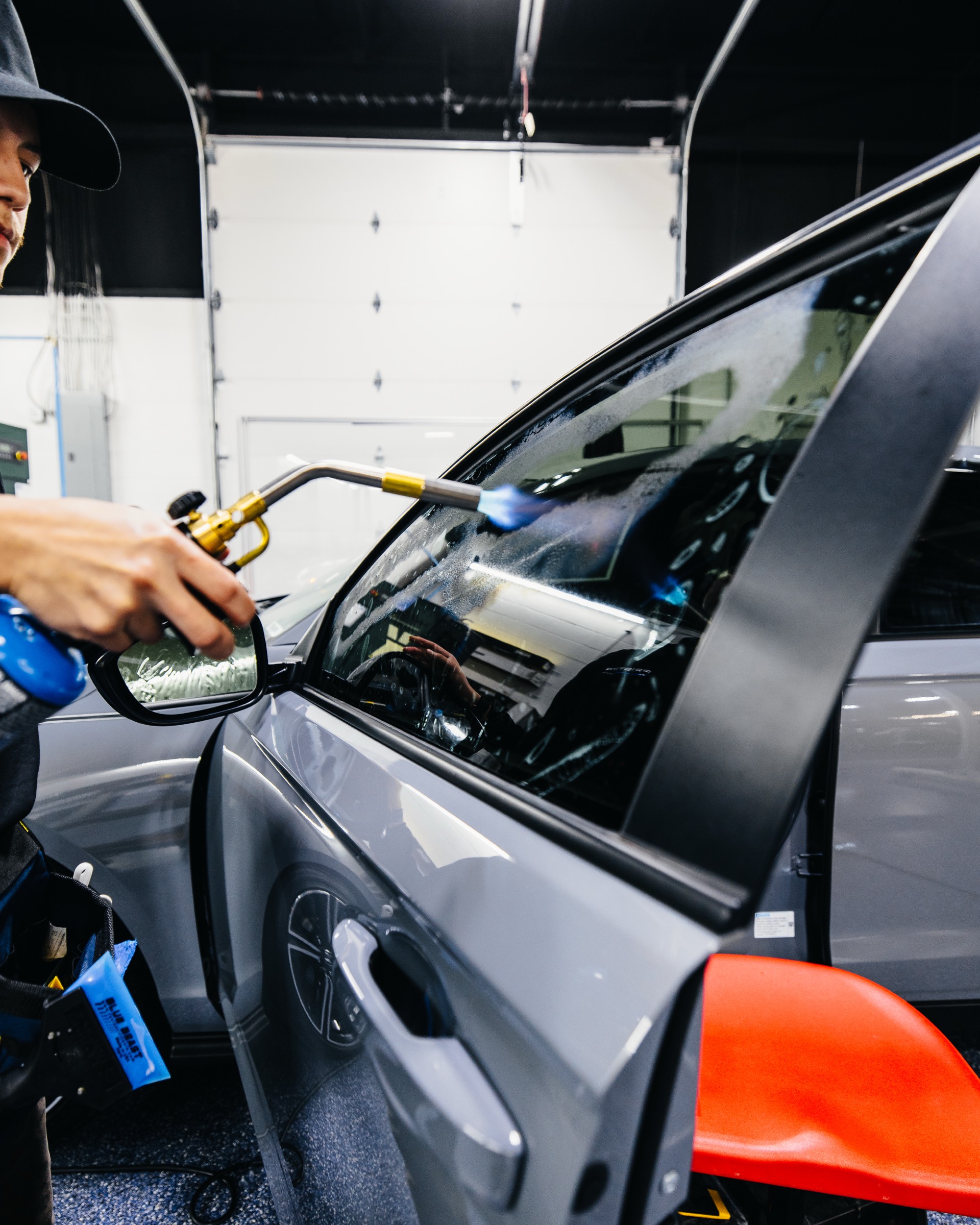 Heat gun shrinking window tint at Pristine Film Solutions